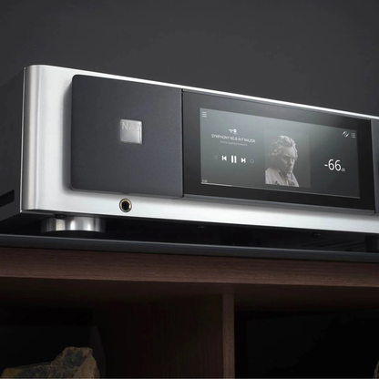 NAD Masters M33 V2 BluOS Streaming DAC Amplifier on timber shelf and dark background