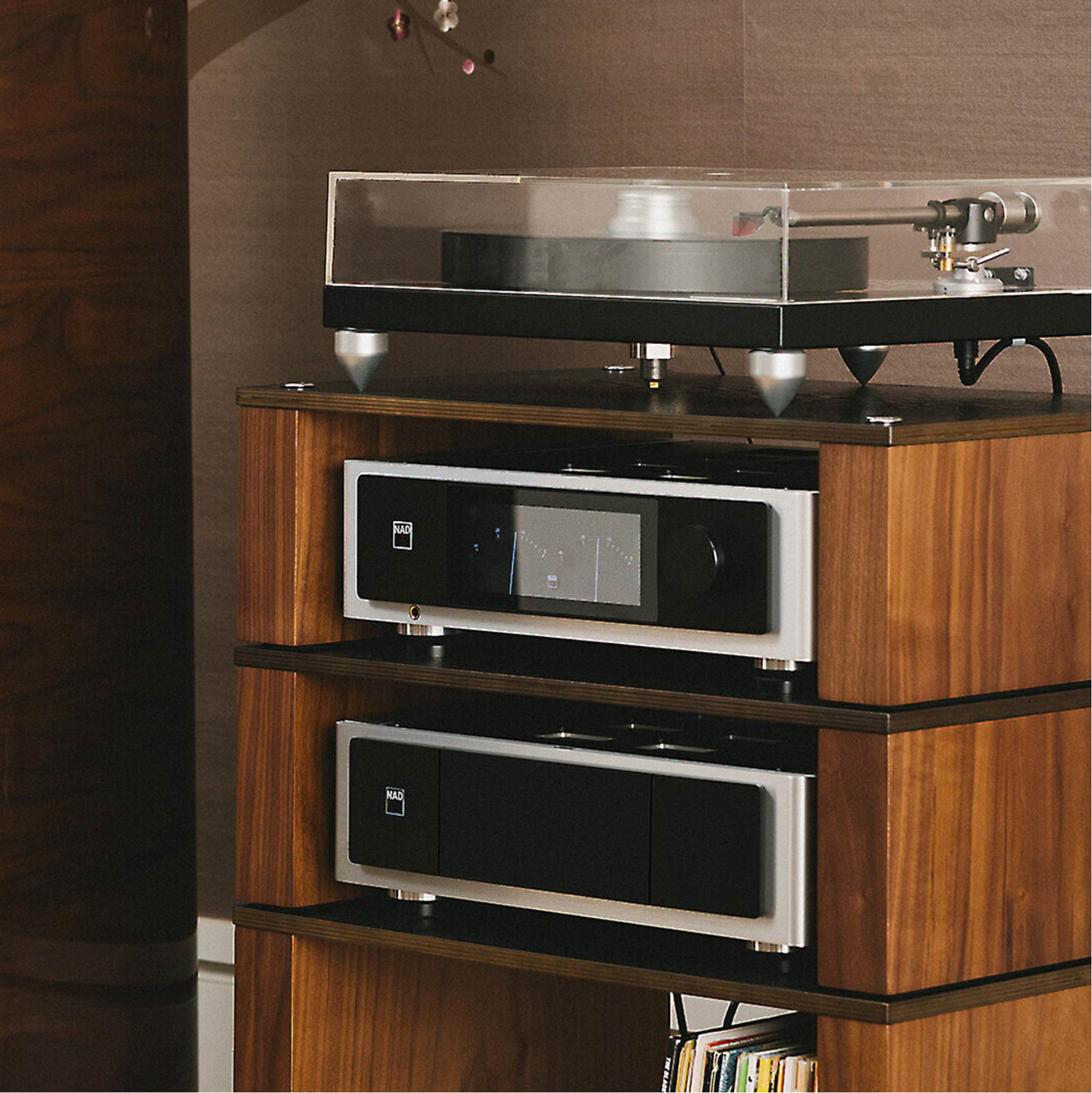 Wooden audio equipment cabinet with turntable and amplifiers on a brown background