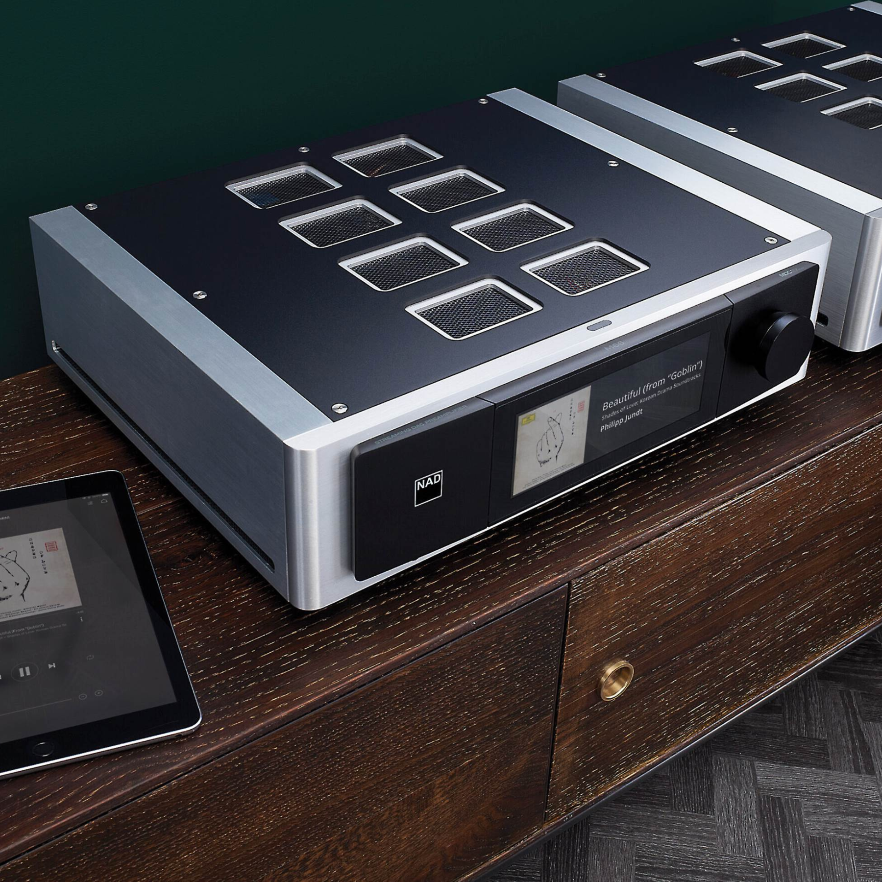 NAD Masters M66 on a wooden surface with a tablet beside it