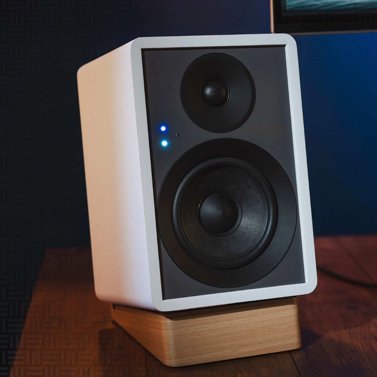 Lifestyle view of white Onkyo GX-10DB Powered Monitor on wooden table