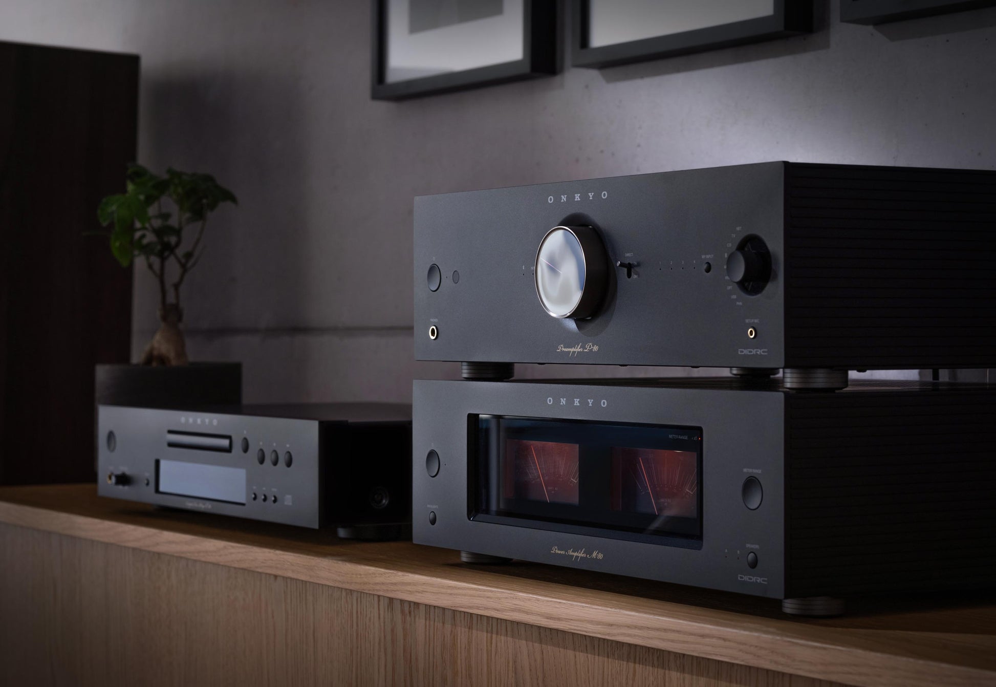 Audio equipment on a wooden shelf with a dark background