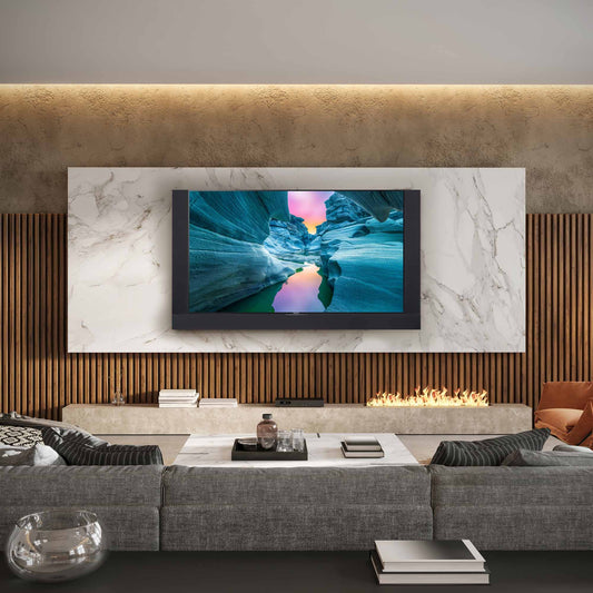 Modern living room with a large TV mounted on a marble wall above a fireplace.