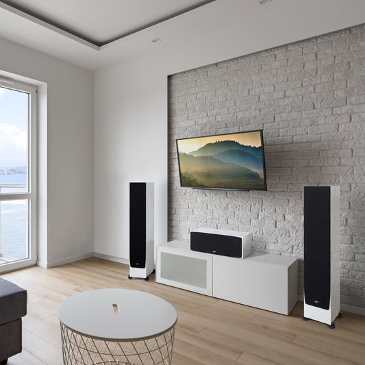 Modern living room with a television, speakers, and a small table.