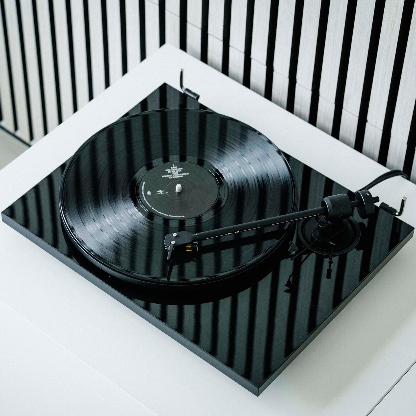 Lifestyle view of Pro-Ject E1 Turntable with Pick It MM E Cartridge in gloss black