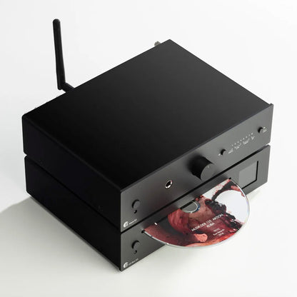 Black audio equipment with a CD on a white background