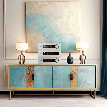 Modern interior with a decorative cabinet, speakers, and lamps against a wall with abstract art.