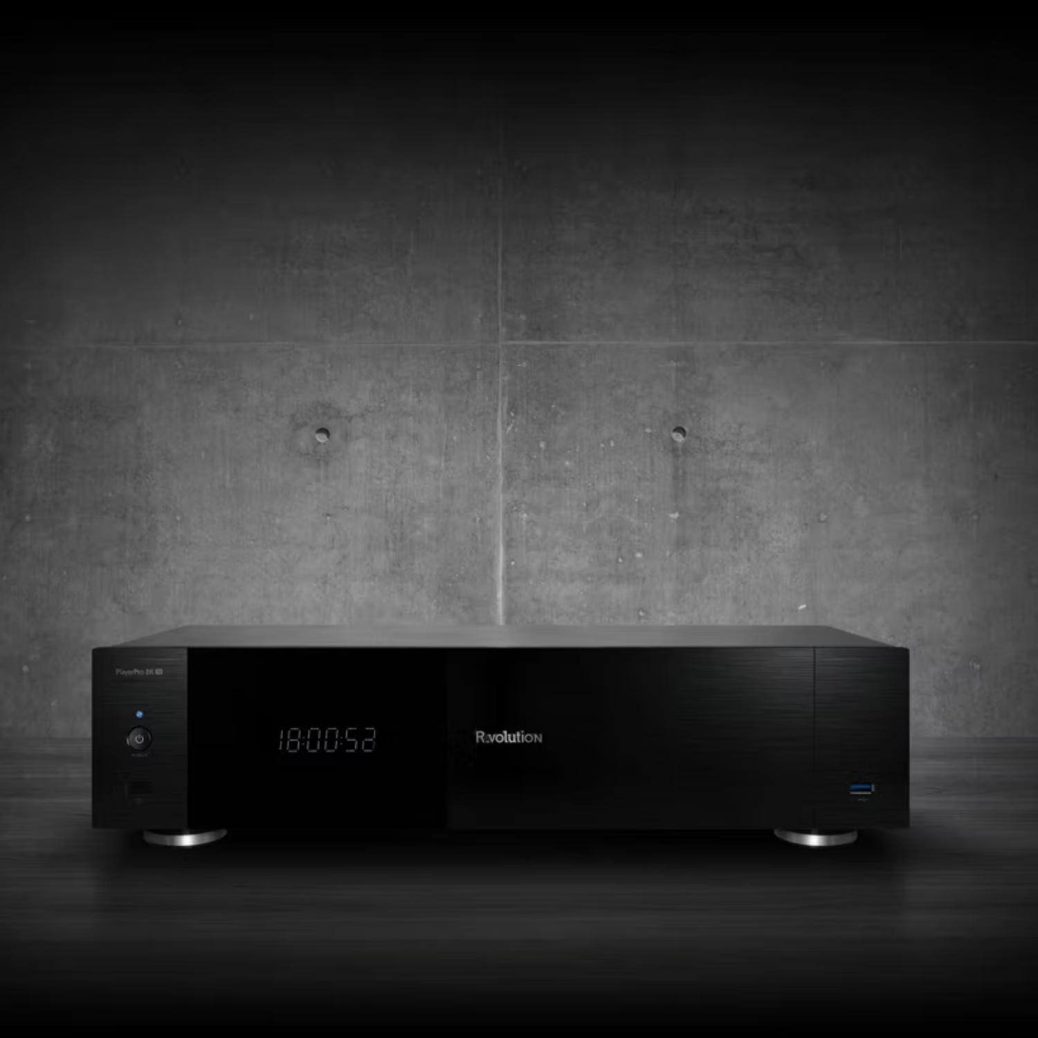 Black electronic device with digital display on a dark concrete wall background