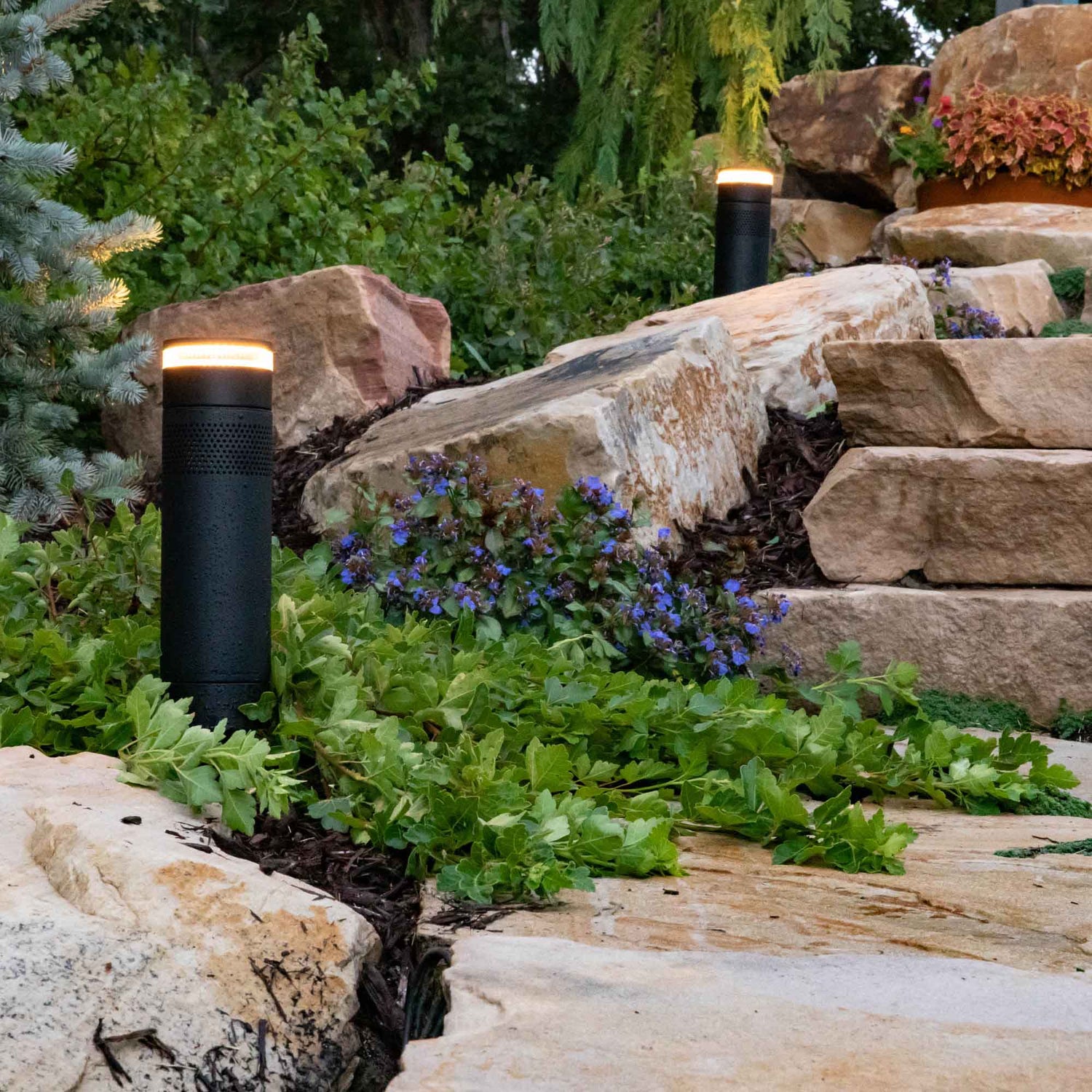 Bollard speakers in garden with lights and speakers