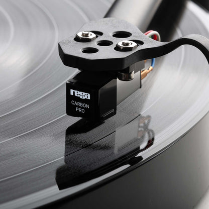 Turntable cartridge on a record with 'Rega' branding