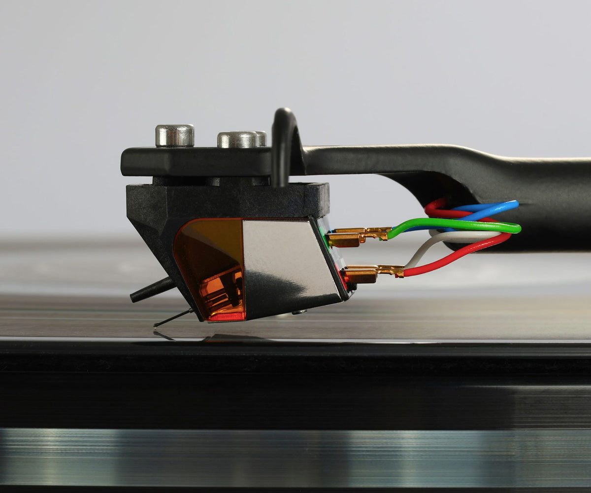 Close-up of a vinyl record player cartridge on a turntable