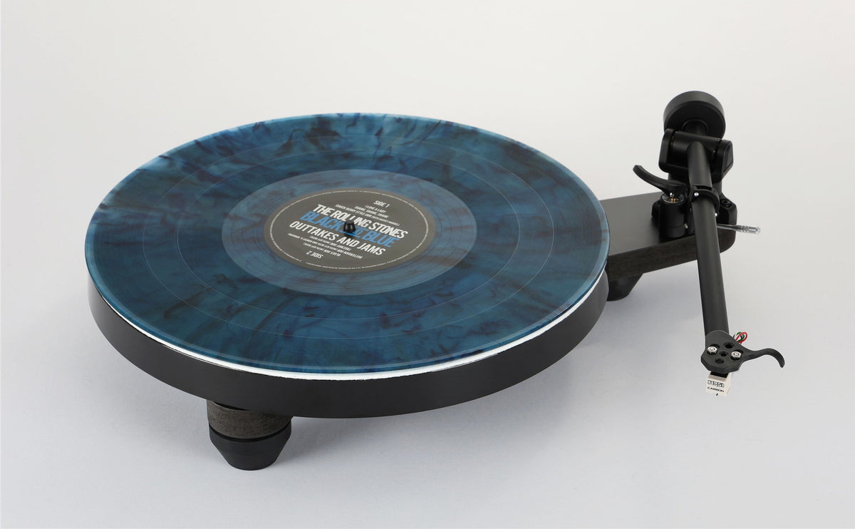 A black turntable with a blue marbled vinyl record on a light gray background.