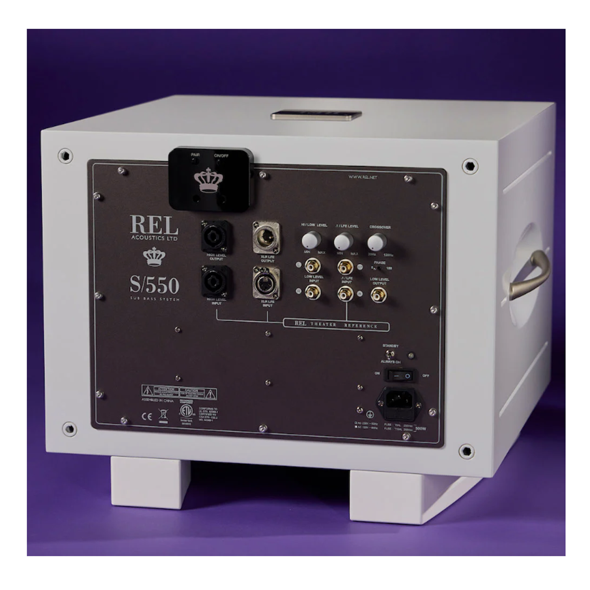 Back panel of a REL S/550 speaker on a purple background with REL Airship Direct Wireless Transmitter
