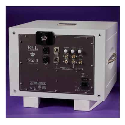 Back panel of a REL S/550 speaker on a purple background with REL Airship Direct Wireless Transmitter