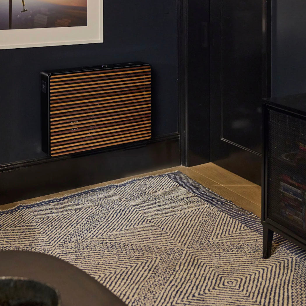 Black REL Planar PL-2 Powered Subwoofer mounted on dark wall