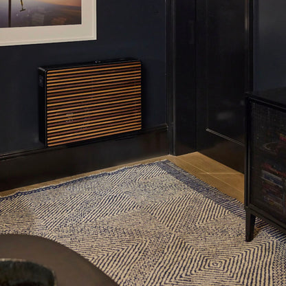 Black REL Planar PL-2 Powered Subwoofer mounted on dark wall