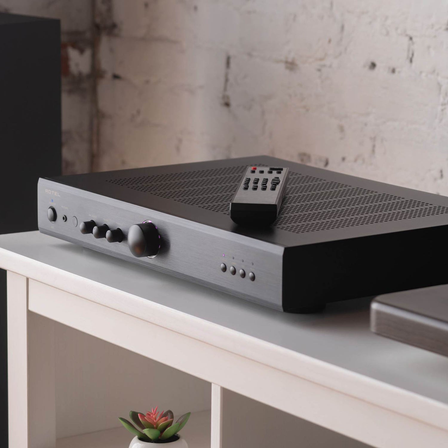 Rotel player on bench with remote control