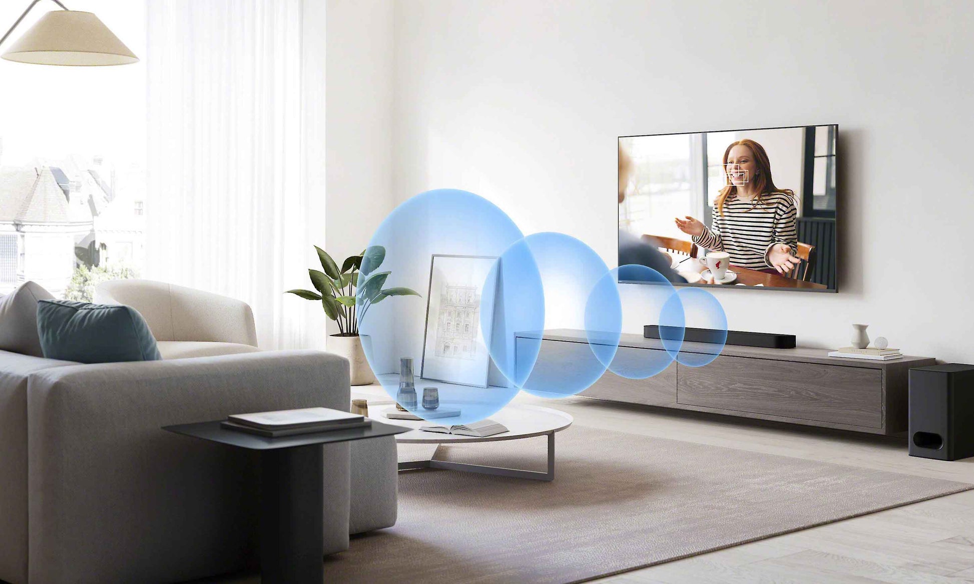 Living room with a TV displaying a woman, surrounded by blue sound waves.