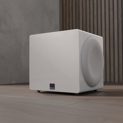 White subwoofer on a wooden floor with a neutral background