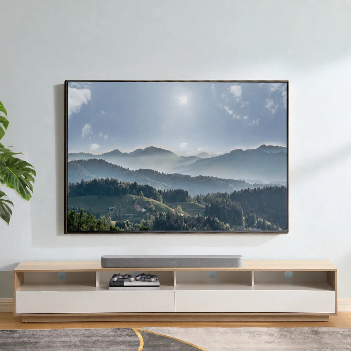 Modern living room with a large TV displaying a mountain scene, below a wooden entertainment console.