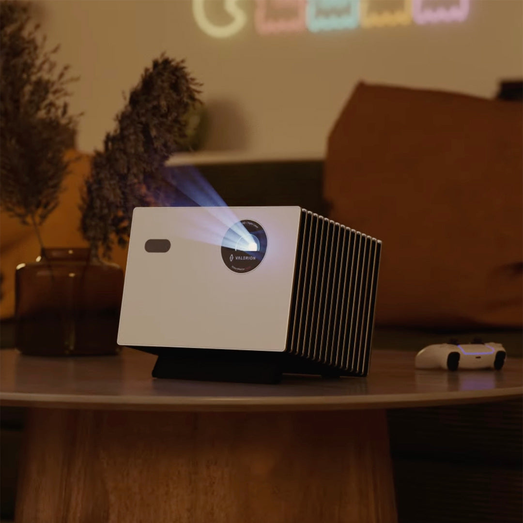 Valerion Projector on a table with a cozy room setting in the background