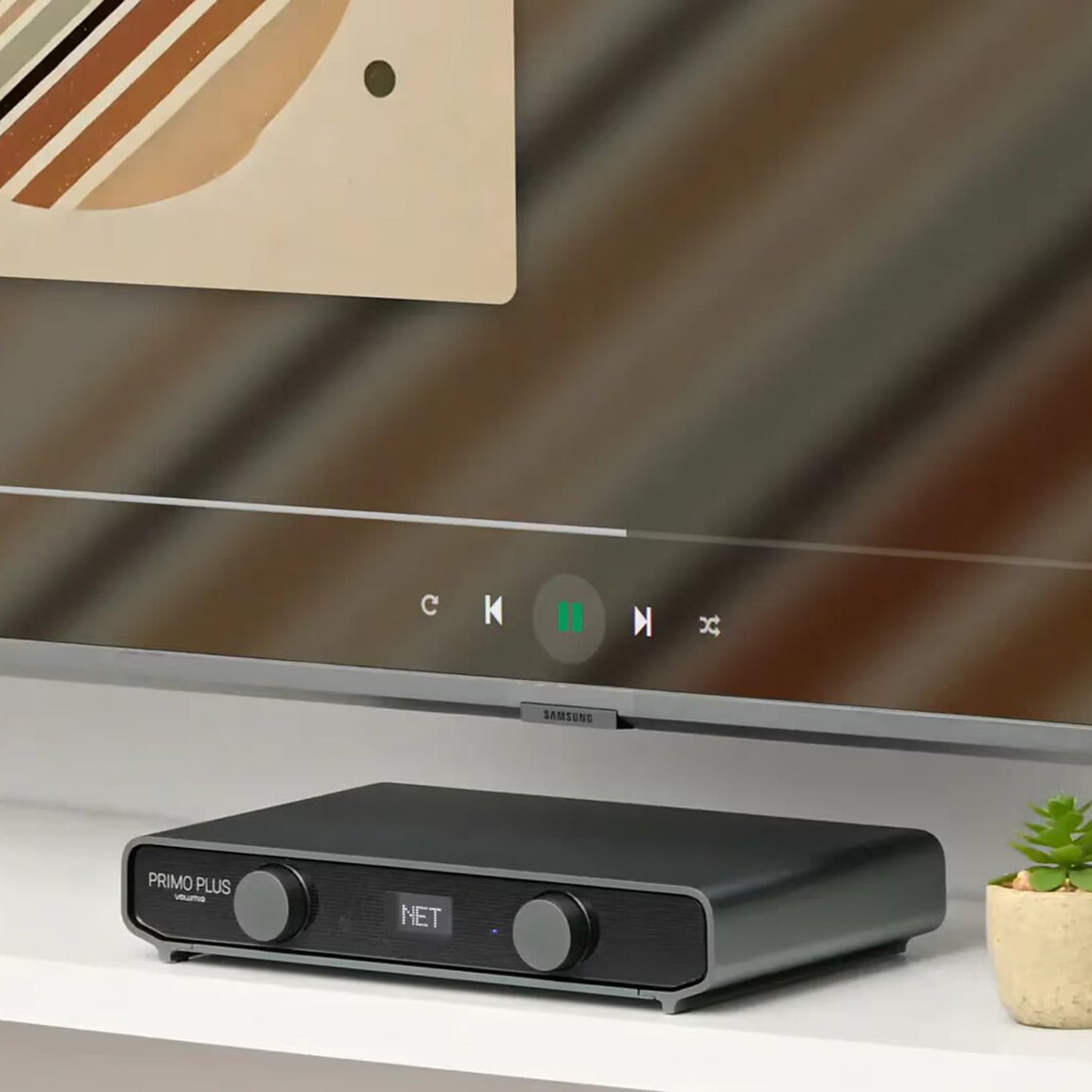 Volumio Primo Plus Network Music Player on white shelf in front of tv screen