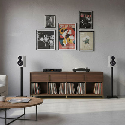 Living room with wooden console table, speakers, and wall art