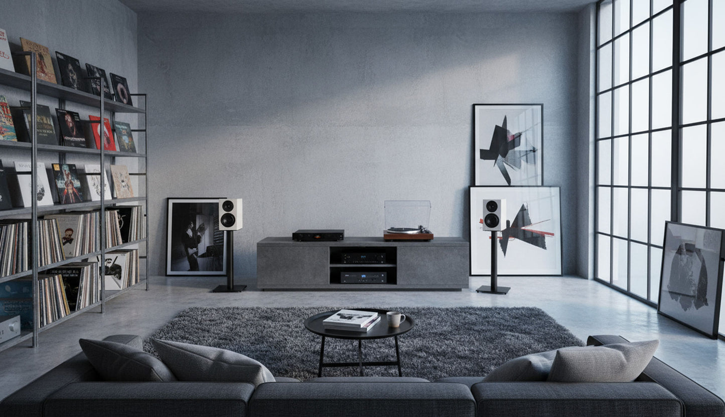 Modern living room with gray sofa, bookshelf, wall art and Wharfedale Diamond 12.1i Speakers
