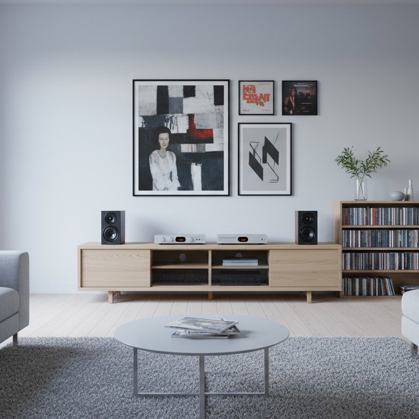 Modern living room with wooden entertainment console, framed art, and bookshelf speakers