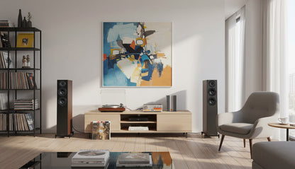 Modern living room with a television, speakers, and a colorful abstract painting.