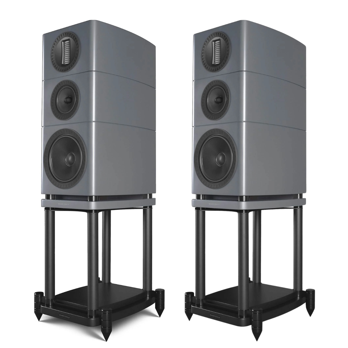 Two grey bookshelf speakers on black metal stands, shown side by side against a plain white background.