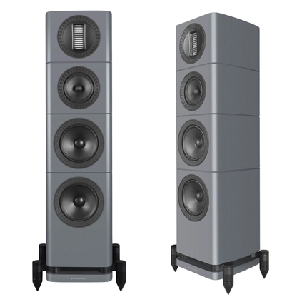 Two tall floorstanding speakers shown side by side on a plain white background. The speakers have a metallic gray finish with black and dark gray drivers and are mounted on black feet.