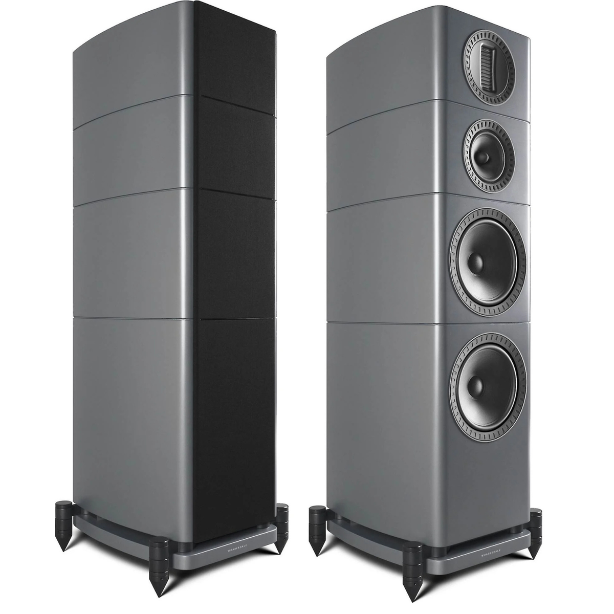 Two grey tower speakers shown side by side on a white background, one showing the rear panel and the other showing the front panel with three driver cones and a top grille.