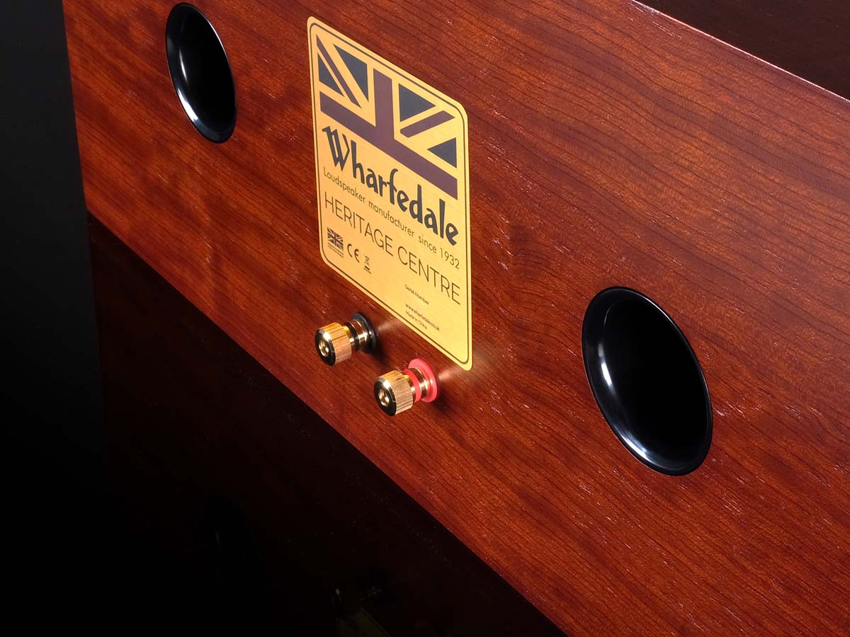 Wooden speaker with a Wharfedale label on a dark background