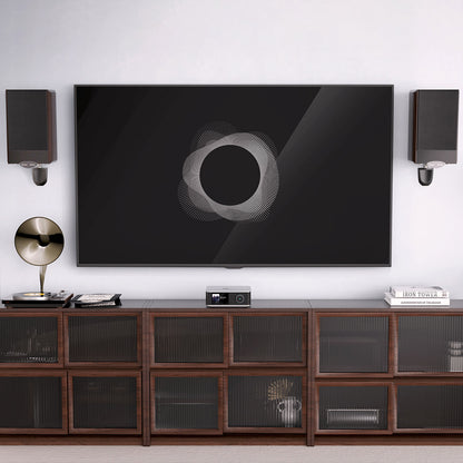 Modern living room with a large TV mounted on the wall, WiiM Amp Ultra Streaming Amplifier and decorative items.