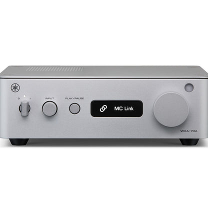 A silver Yamaha WXA-70A receiver or amplifier with a black central display screen showing 'MC Link' and a large round control knob on the right side, photographed against a plain white background.