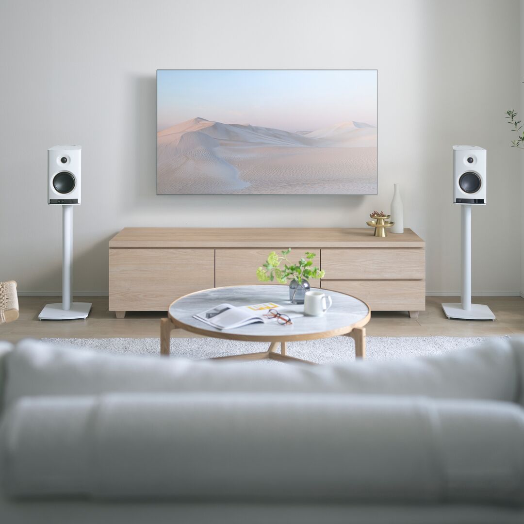 Living room with a TV, speakers, and a coffee table.
