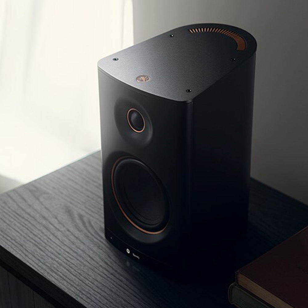 Black Yamaha NX-70A Wireless Hi-Fi Speaker System sitting on black shelf