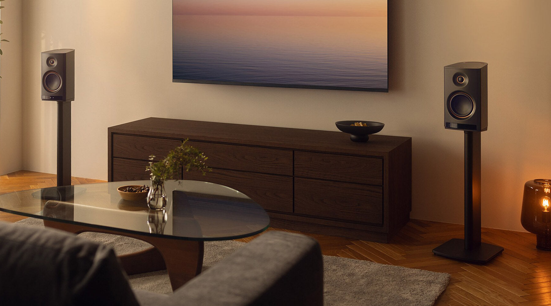 Living room with a television, speakers, and a coffee table.